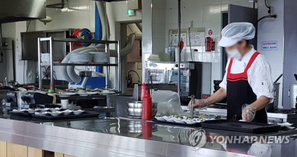 식당 주방에서 한 여성 노동자가 손님에게 제공할 음식을 준비하고 있다. [연합뉴스 자료사진]