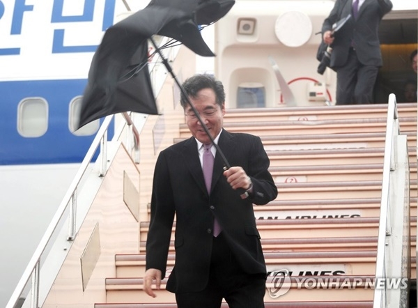 이낙연 국무총리가 22일 일왕 즉위선언식 참석차 대통령 전용기로 일본 하네다 공항에 도착한 뒤 돌풍에 뒤집어진 우산을 들고 트랩을 내려오고 있다.(사진=연합뉴스)
