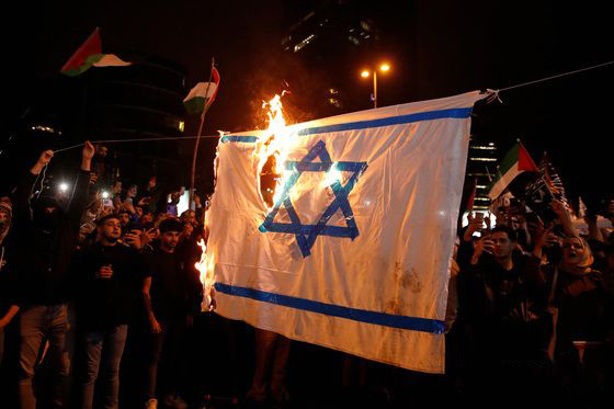 가자 지구 병원 공습으로 수백명의 팔레스타인인들이 사망하는 사건이 발생하자 18일(현지시간) 시위자들이 이스라엘 국기에 불을 붙이고 있다. [로이터연합]